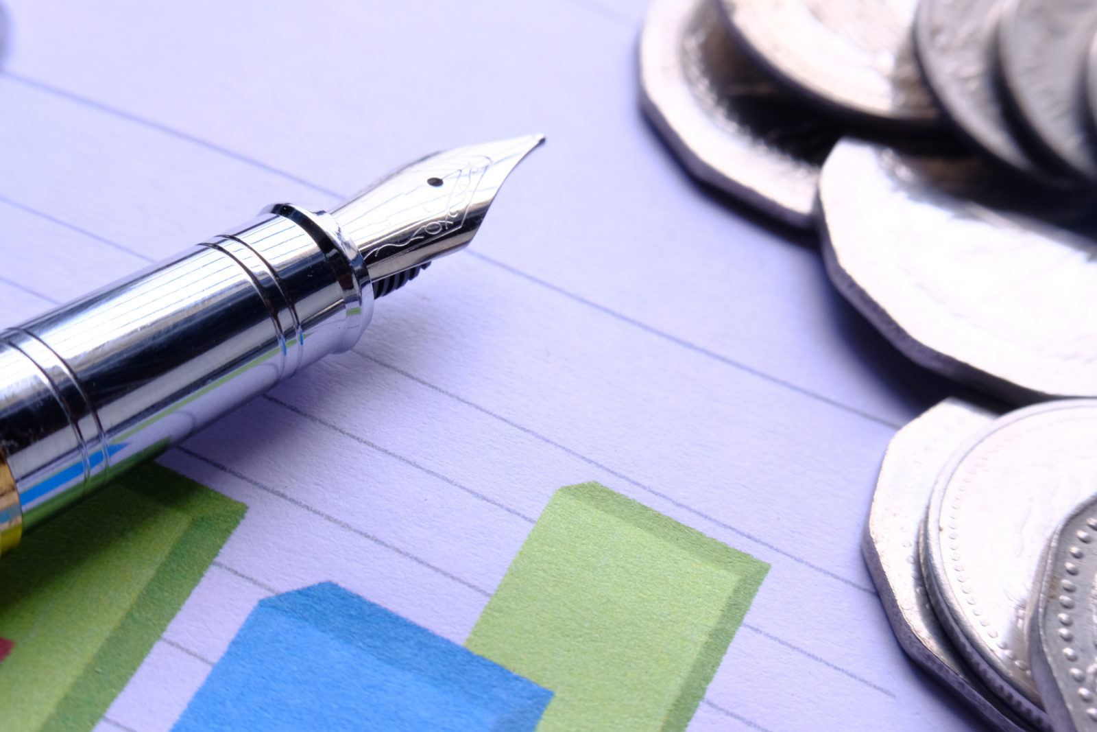 Saving stack coins money concept,graph,chart document and pen on desktop desk